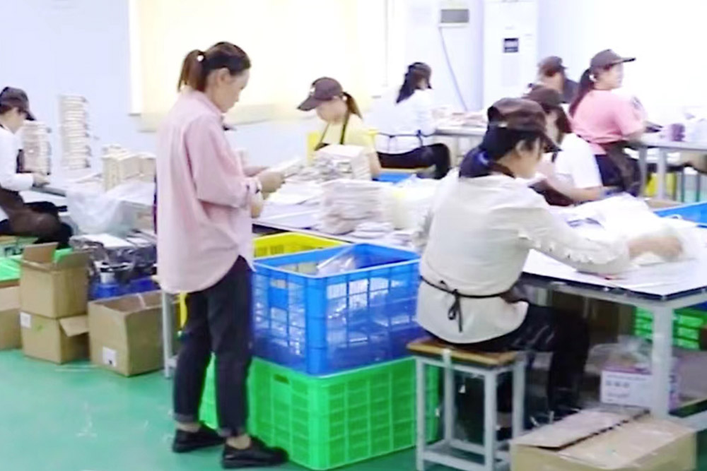 A worker inspects the production line